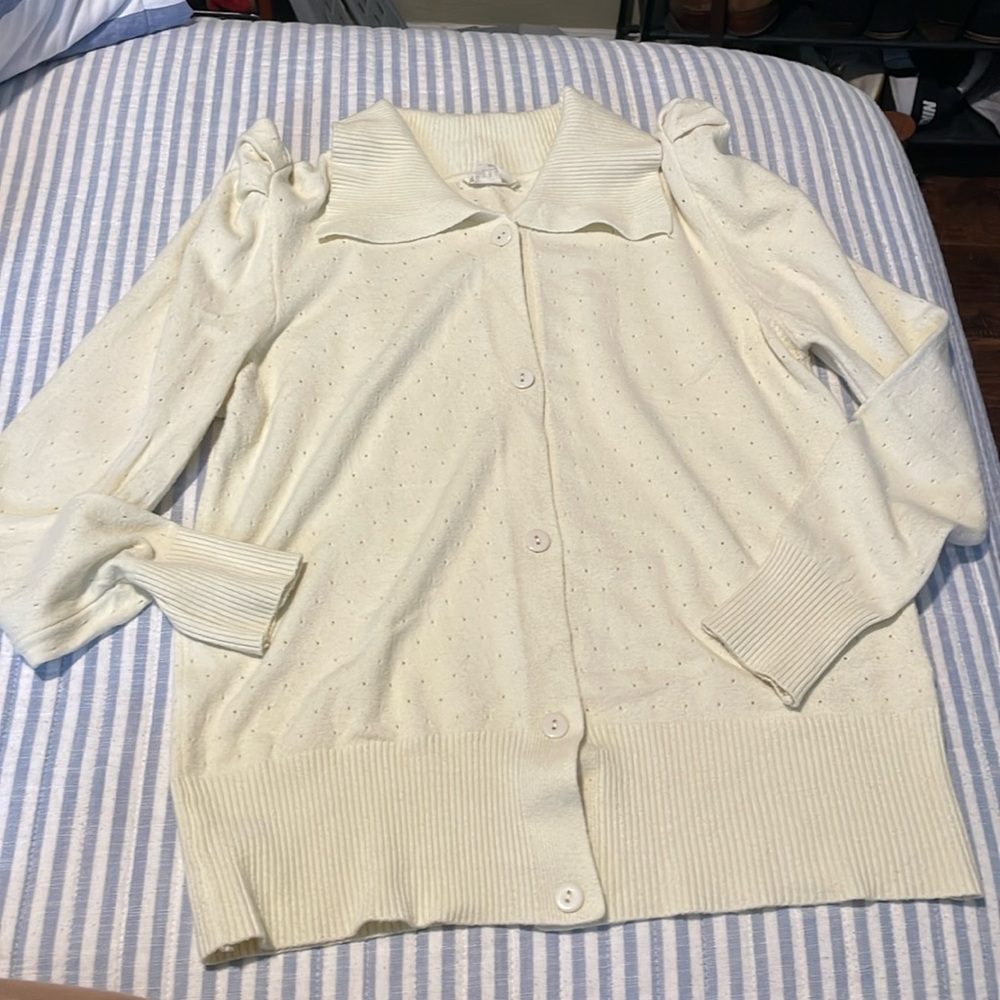 Adorable light weight sweater in a light yellow